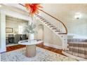 Elegant foyer featuring a curved staircase, marble table, and stylish chandelier at 1333 Carlton Ave, Charlotte, NC 28203