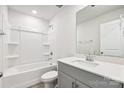Bathroom featuring a shower-tub combo and a vanity with grey cabinets and white countertop at 1515 Harper Landing Blvd, Stanley, NC 28164