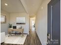 Bright entryway with hardwood floors, leading to a home office and other rooms at 1515 Harper Landing Blvd, Stanley, NC 28164