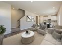 Open living space with a staircase, and a view into the kitchen area at 1515 Harper Landing Blvd, Stanley, NC 28164