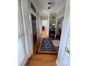 Inviting entryway featuring hardwood floors, a stylish rug, and a dark wood front door at 1601 Eden Glen Dr, Dallas, NC 28034