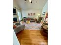 Spacious living room featuring hardwood floors, a cozy seating area, and a vaulted ceiling at 1601 Eden Glen Dr, Dallas, NC 28034