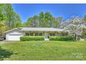 Charming ranch-style home featuring a welcoming front porch and lush green lawn at 16415 Capps Rd, Charlotte, NC 28278