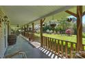 Inviting covered front porch with wooden railings and scenic views of the surrounding greenery at 16415 Capps Rd, Charlotte, NC 28278