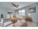 Comfortable living room featuring neutral furniture and large windows at 2208 Pennick Ct, Harrisburg, NC 28075