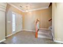 Bright entryway with tile flooring, staircase, and a coat closet at 3043 Streamlet Way, Monroe, NC 28110
