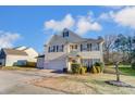 Two-story house with beige siding, dark shutters, and a two-car garage at 3043 Streamlet Way, Monroe, NC 28110