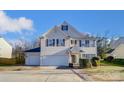 Two-story house with beige siding, dark shutters, and a two-car garage at 3043 Streamlet Way, Monroe, NC 28110