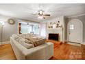 Spacious living room with hardwood floors, fireplace, and sectional sofa at 402 Fisher St, Concord, NC 28027