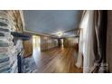 Living room with brick fireplace and wood-paneled walls at 4536 Jim Beard Rd, Maiden, NC 28650