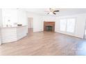 Open living room with hardwood floors, a fireplace and large windows at 461 Ret Stafford Ln, Taylorsville, NC 28681