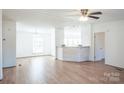 Spacious living room with hardwood floors, a fireplace, and a breakfast bar at 461 Ret Stafford Ln, Taylorsville, NC 28681