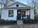 Newly renovated white house featuring a gray porch and brick steps at 563 Sparta Nw St, Concord, NC 28025