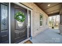 Dark brown front door with sidelights and a wreath at 604 Impala Dr, Albemarle, NC 28001