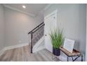 Modern staircase with dark metal railing and wood flooring at 604 Impala Dr, Albemarle, NC 28001
