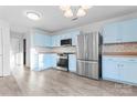 Kitchen with light blue cabinets and stainless steel appliances at 9321 Bayview Pkwy, Charlotte, NC 28216