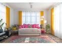 A colorful, cozy bedroom featuring vibrant textiles, plants, and a large window for plenty of natural light at 935 Mcalway Rd # 306, Charlotte, NC 28211