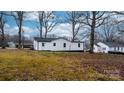 Back of house showing a large backyard with mature trees at 1940 33Rd Ne Ave, Hickory, NC 28601