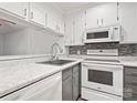 Modern kitchen features white cabinets, gray countertops, and stainless steel appliances at 1985 Lancer Ct, Gastonia, NC 28054
