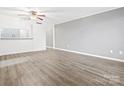 Spacious living room with gray walls, wood-look floors, and ceiling fan at 1985 Lancer Ct, Gastonia, NC 28054