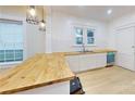 Updated kitchen, featuring butcher block countertops and white cabinets at 212 E Eleventh St, Salisbury, NC 28144