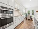 Modern kitchen showcasing stainless steel appliances and a view into the bright breakfast nook at 212 Portrait Way, Indian Trail, NC 28079