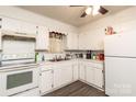 Bright kitchen with white cabinets, modern appliances, and ample counter space for meal preparation at 2485 Nc Highway 109 S Hwy, Mount Gilead, NC 27306