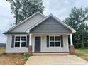 Newly built home with gray siding, gray roof, and a concrete driveway at 285 E Steele St, Salisbury, NC 28144