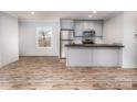 Modern kitchen with gray cabinets and stainless appliances at 607 Stewart Ct, Statesville, NC 28677