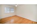 Bright bedroom with hardwood floors and two windows at 644 Dogwood Rd, Statesville, NC 28677