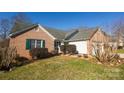 Brick home with green shutters and a well-maintained lawn at 730 Hidden Creek Cir, Salisbury, NC 28147