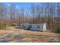 Mobile home exterior view with shed and wooded area at 102 Lansdale Ave, Lincolnton, NC 28092