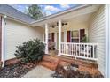 Covered front porch with white railings and ceiling fan at 1055 Cedar Hills Ln, Lancaster, SC 29720