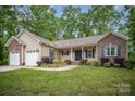 Charming single-story home with a brick-accented facade, attached two-car garage, and well-manicured lawn at 1313 Western Hills Ln, Vale, NC 28168