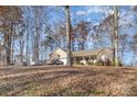 House nestled in wooded lot with ample parking at 1313 Western Hills Ln, Vale, NC 28168