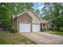 A single story home with attached garage and nice landscaping at 1313 Western Hills Ln, Vale, NC 28168