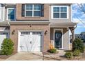 Brick and siding townhome with two-car garage and landscaping at 13417 Savannah Club Dr, Charlotte, NC 28273