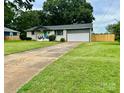 Ranch home with driveway and grassy front yard at 1535 Rolling Meadow Ln, Gastonia, NC 28054