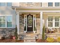 Inviting front porch with stone details and cozy seating at 1801 Pin Oak Ct, Fort Mill, SC 29715