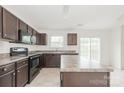 Eat-in kitchen with dark wood cabinets, granite countertops, and stainless steel appliances at 1806 Eastway Dr, Dallas, NC 28034