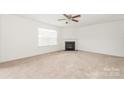 Living room with neutral carpeting, a corner fireplace, and a ceiling fan at 1806 Eastway Dr, Dallas, NC 28034