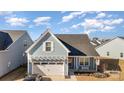 Aerial view of charming house, two-car garage, and neighborhood at 194 Tillery Ln, Mount Gilead, NC 27306