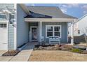 Inviting front porch with white bench, landscaping, and front door at 194 Tillery Ln, Mount Gilead, NC 27306