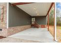 Covered porch with concrete flooring and stairs leading to the house at 2434 Wo Gladden Rd, Chester, SC 29706