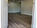 View from entry door showing dark wood-look flooring and interior doors at 3225 Cricketeer Dr, Charlotte, NC 28216