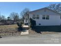 White brick side of house with walkway leading to the entrance at 3225 Cricketeer Dr, Charlotte, NC 28216