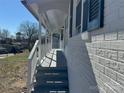 White brick exterior with a long covered porch and white railing at 3225 Cricketeer Dr, Charlotte, NC 28216