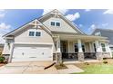 Two-story home with stone accents and a front porch at 4010 Cedar Falls Dr # 23, Waxhaw, NC 28173