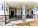 Covered front porch with stone columns and flooring at 4010 Cedar Falls Dr # 23, Waxhaw, NC 28173
