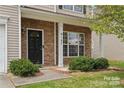 Front door entrance with stone accents and landscaping at 6107 Follow The Trl, Indian Trail, NC 28079